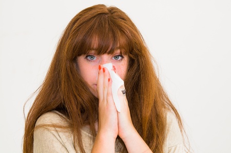 woman using tissue on white backgroundの写真素材