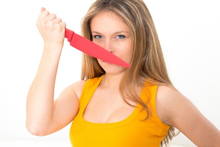 Woman with a knife on a white backgroundの写真素材