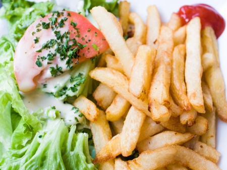 Golden French fries potatoes ready to be eatenの写真素材