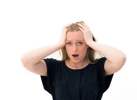 Young woman screaming. against a white background.の写真素材