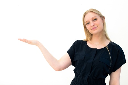 woman showing and smiling looking at camera explaining with gesture on white background.の写真素材