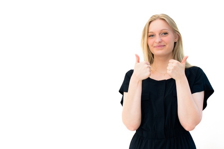young smiling woman thumb as a sign of approval on the white backgroundの写真素材