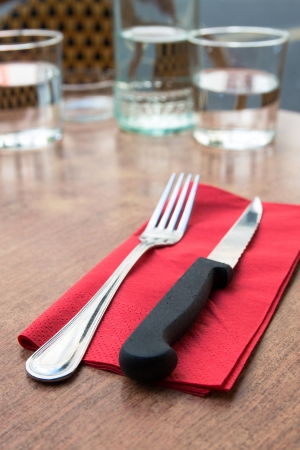 place setting - plate, knife and fork on tableの写真素材