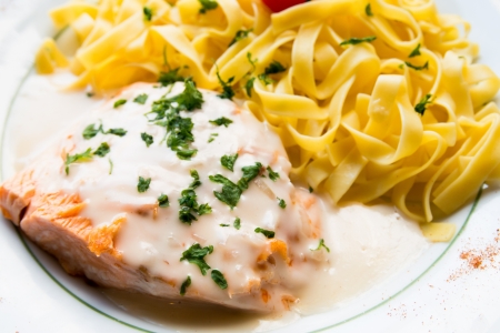 tasty pasta with salmon on a the tableの写真素材