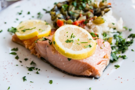 grilled salmon and rice-french cuisine dish with tomato and salmonの写真素材