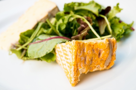 delicious cheese with lettuce on tableの写真素材