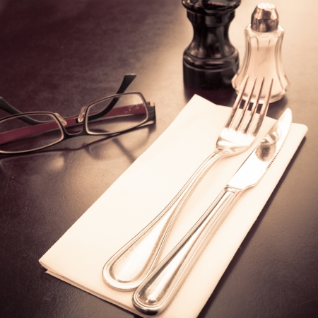 place setting - plate, knife and fork on tableの写真素材
