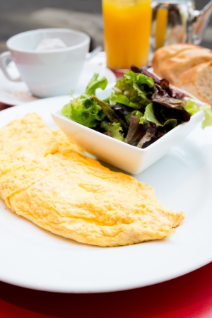 Breakfast with coffee and croissants in a basket on tableの写真素材