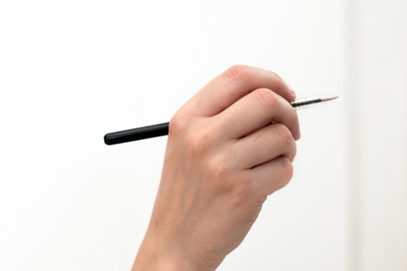 Close up of woman hand writing, Isolated on white backgroundの写真素材