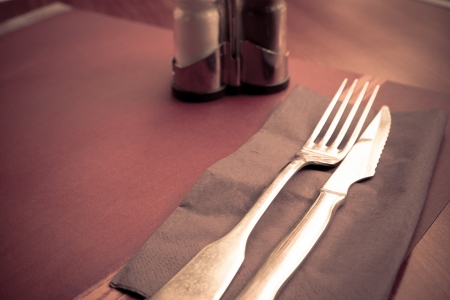 place setting - plate, knife and fork on tableの写真素材
