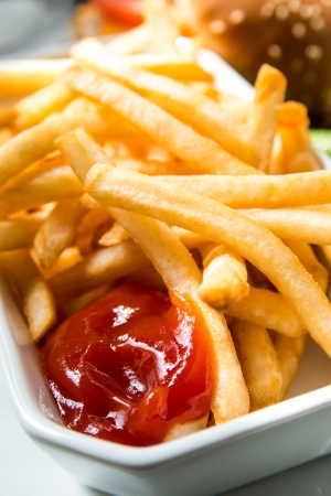 Golden French fries potatoes ready to be eatenの写真素材