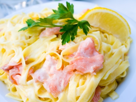 tasty pasta with salmon on a the tableの写真素材