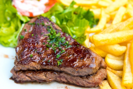 juicy steak beef meat with tomato and french friesの写真素材