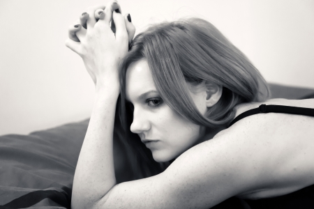 Beautiful young woman in lingerie on the bedの写真素材