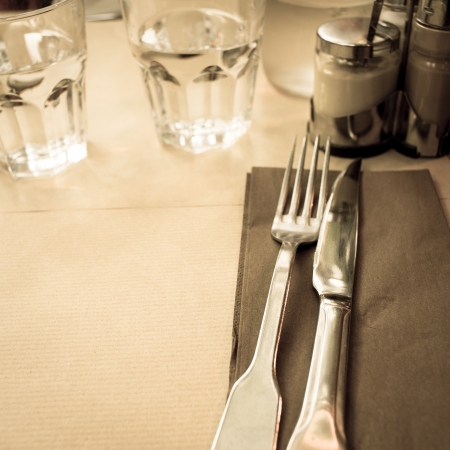 table setting - plate, knife and fork on tableの写真素材