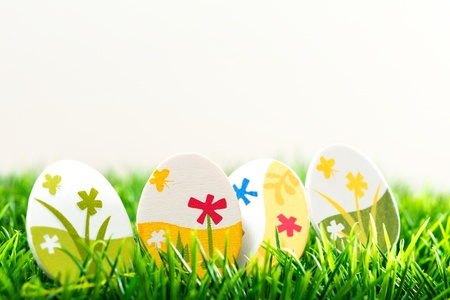 Colorful chocolate easter eggs on green grass