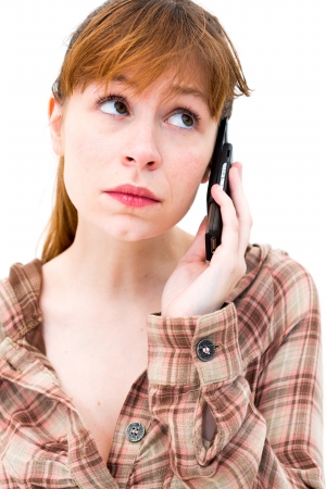 thinking woman with phone on white backgroundの写真素材