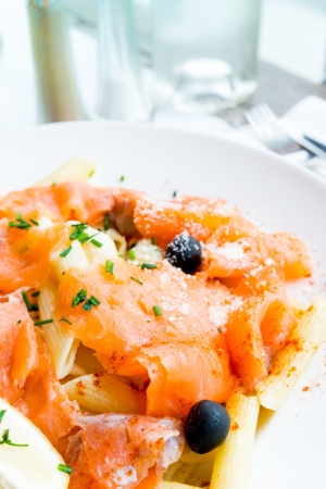tasty pasta with salmon on a the tableの写真素材