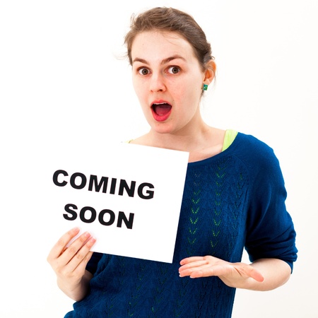 Dramatic young woman with board coming soonの写真素材