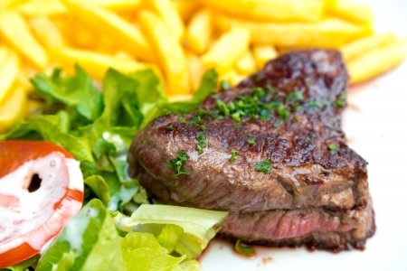 juicy steak beef meat with tomato and potatoesの写真素材