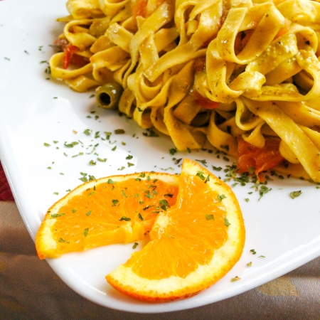 tasty pasta with roast ham on the table-take with mobile phoneの写真素材