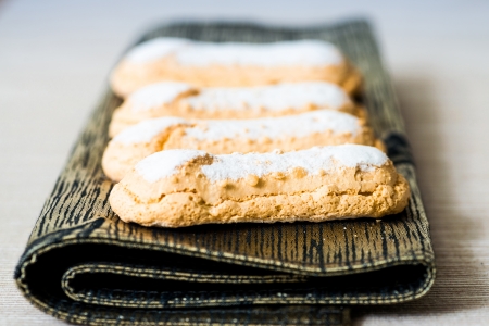 sponge fingers sugar biscuit on brown napkin