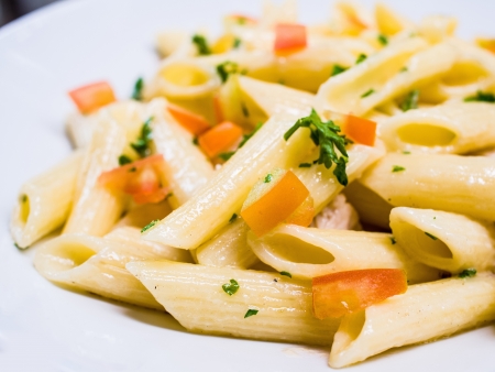 close-up of plate of pasta and chicken with lettuceの写真素材