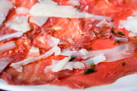 Fresh Sliced raw beef meat with leaf lettuce on the table の写真素材