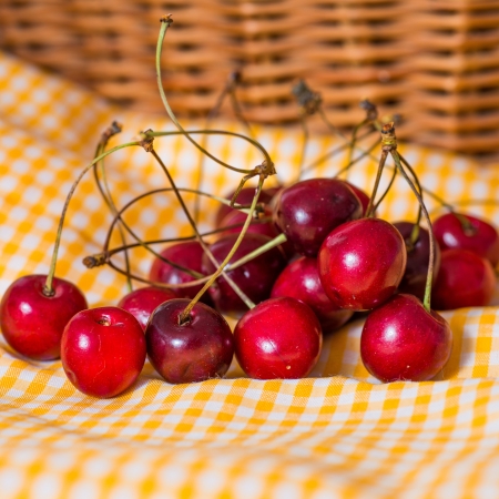 fresh cherries on yellow napkinの写真素材