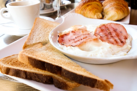 Breakfast with coffee and croissants on tableの写真素材