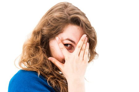 woman hiding face laughing timid on white background の写真素材