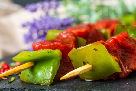 tasty beef steak kabobs with vegetables on a slate plate の写真素材