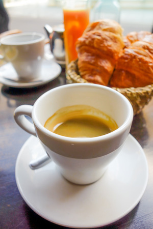 Breakfast with coffee and croissants on tableの写真素材