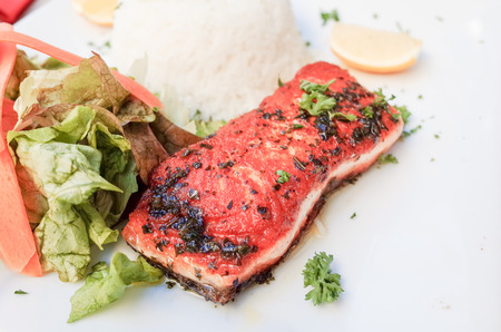 grilled salmon and lemon - french cuisine dish with tomato and salmon