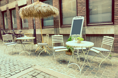 European Street view of a coffee terrace with tables and chairsのeditorial素材