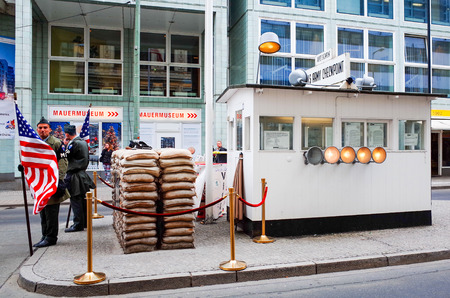 BERLIN, GERMANY-APRIL 18: Checkpoint Charlie on April 18, 2014. It's the best-known Berlin Wall crossing point between East Berlin and West Berlin during the Cold War.のeditorial素材