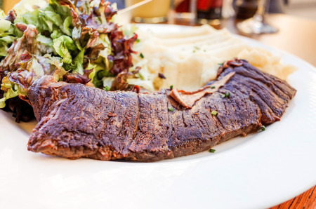 juicy steak beef meat with tomato and potatoesの写真素材