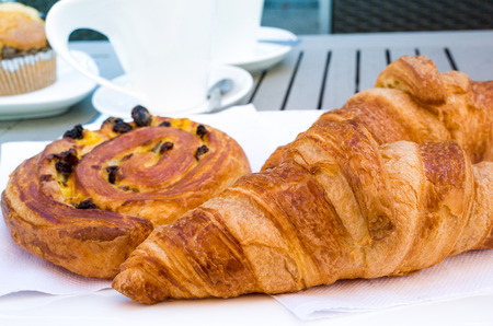 Breakfast with coffee and croissants on tableの写真素材