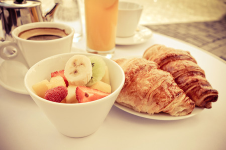 Breakfast with coffee and croissants on tableの写真素材