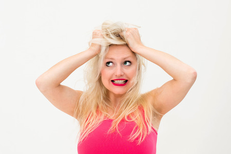 Young panic woman with hands on the headの写真素材