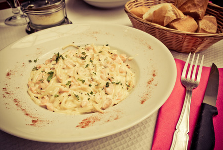 tasty pasta with salmon on a the tableの写真素材