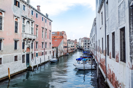 Tourists on water street with Gondola in Venice on May 26, 2015. its entirety is listed as a World Heritage Site, along with its lagoon.May 26 VENICE, ITALYのeditorial素材