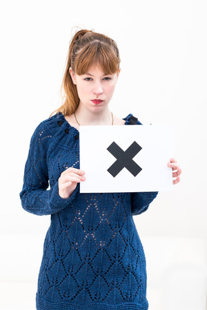 unhappy portrait young woman with board NOの写真素材