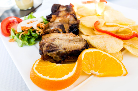 Grilled steak - Grilled meat ribs on the plate with hot sauceの写真素材