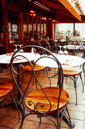 Street view of a coffee terrace with tables and chairs in europeの写真素材