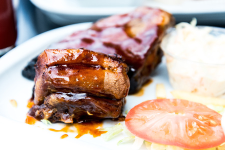 Grilled steak - Grilled meat ribs on the plate with hot sauce