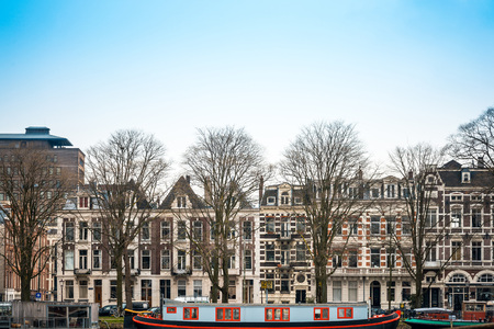 Amsterdam, Netherlands.-March 16, 2016 : Beautiful view of Amsterdam canals with bridge and typical dutch houses. Amsterdam, Netherlandsの写真素材