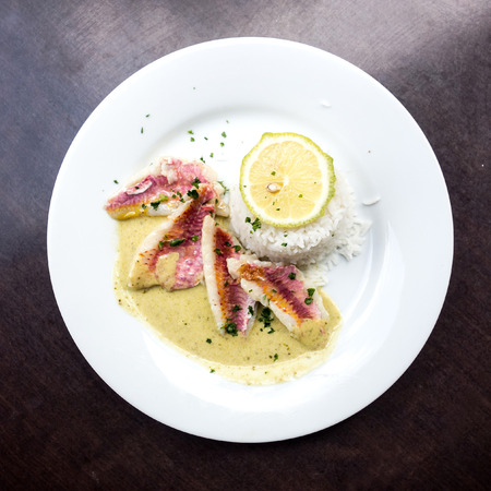 grilled fish and rice-french cuisine dish with lemon and fish