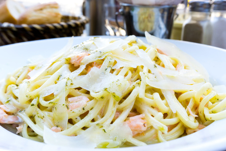 tasty pasta with salmon on a the tableの写真素材