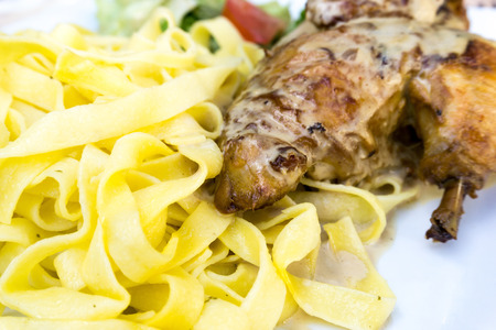 pasta and chicken on the tableの写真素材